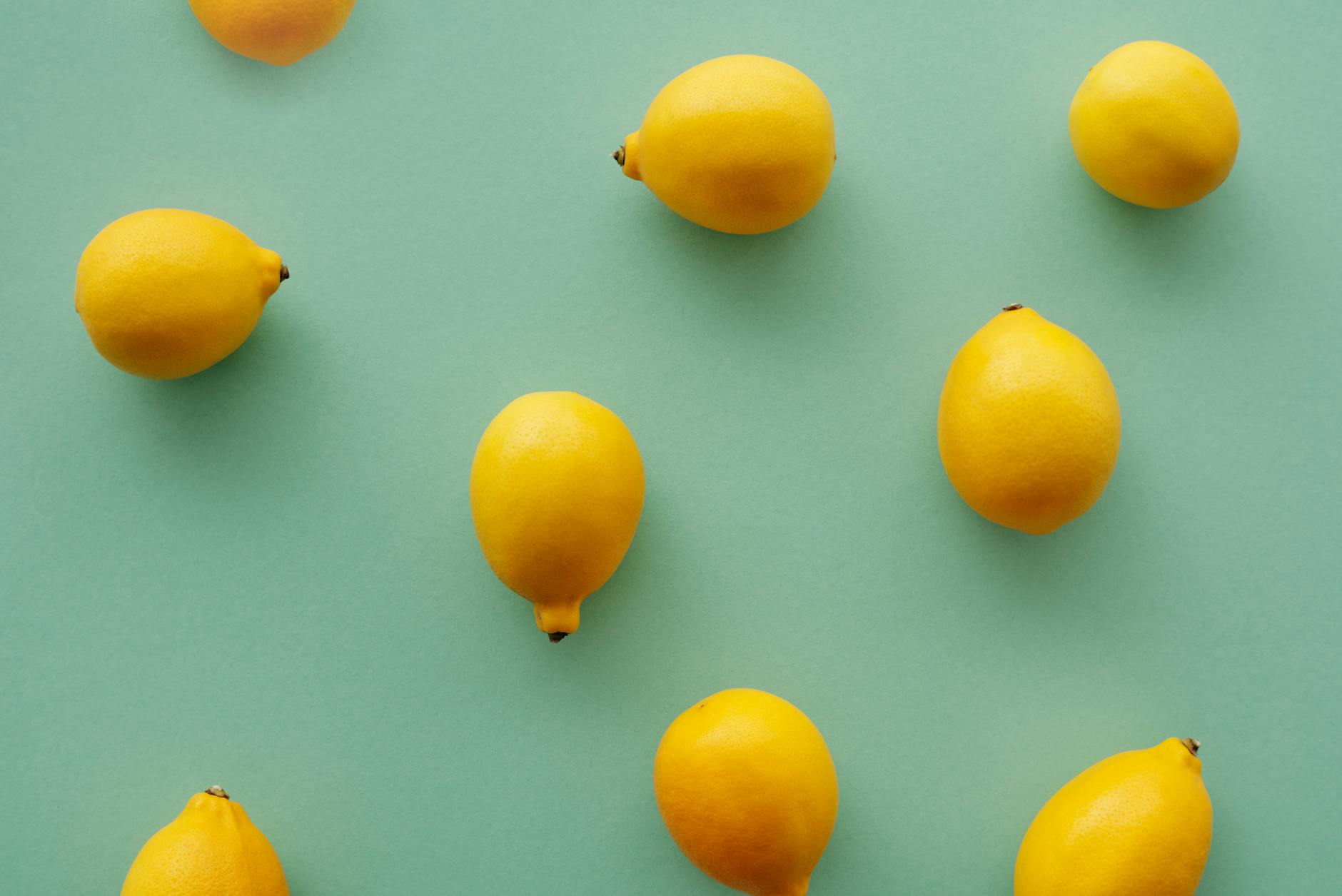 Bright ripe lemons with pleasant aroma arranged on a pastel background, symbolizing freshness and renewal