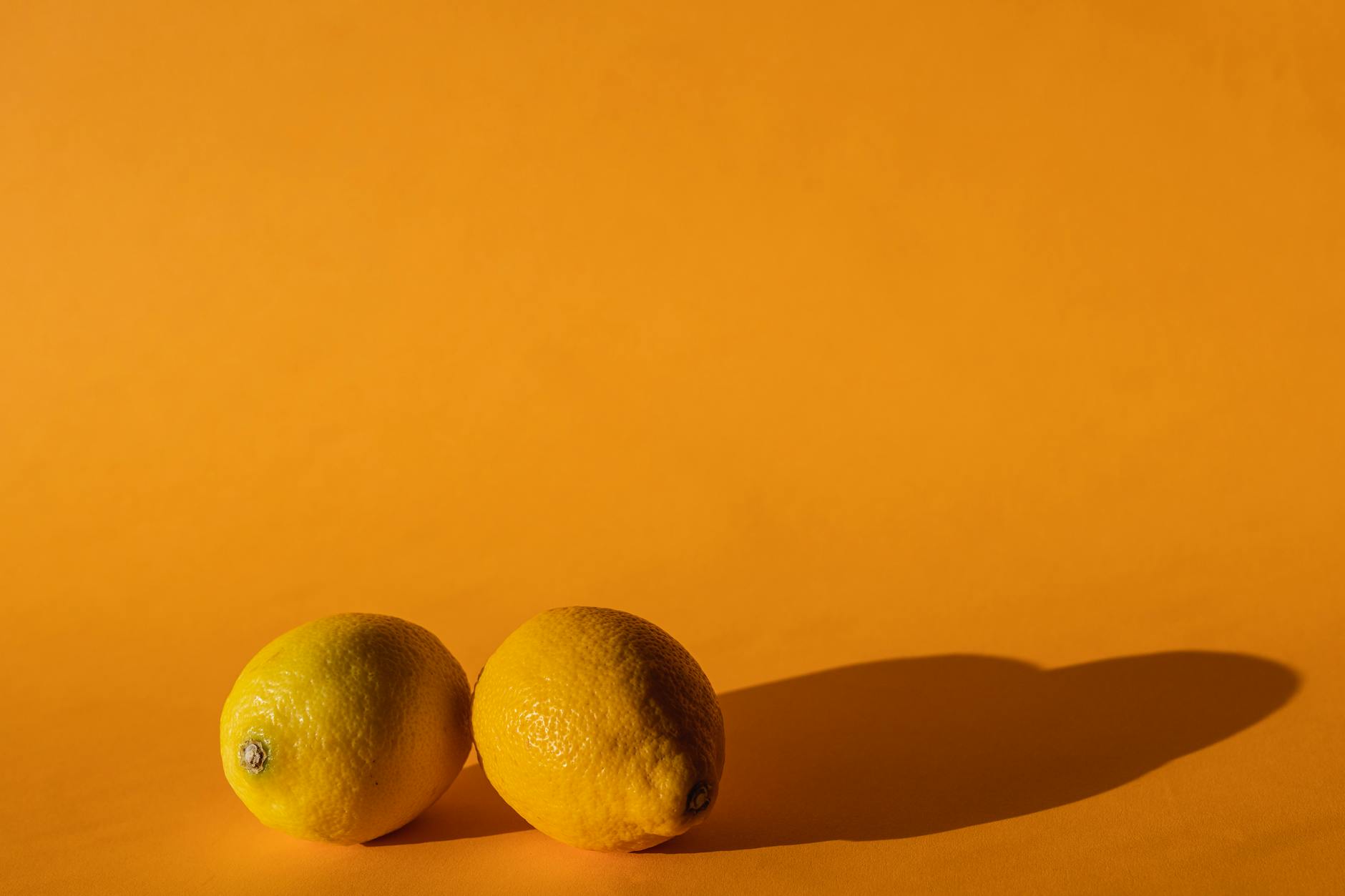 Two lemons held gently in cupped hands, symbolizing returning to sensual touch with care