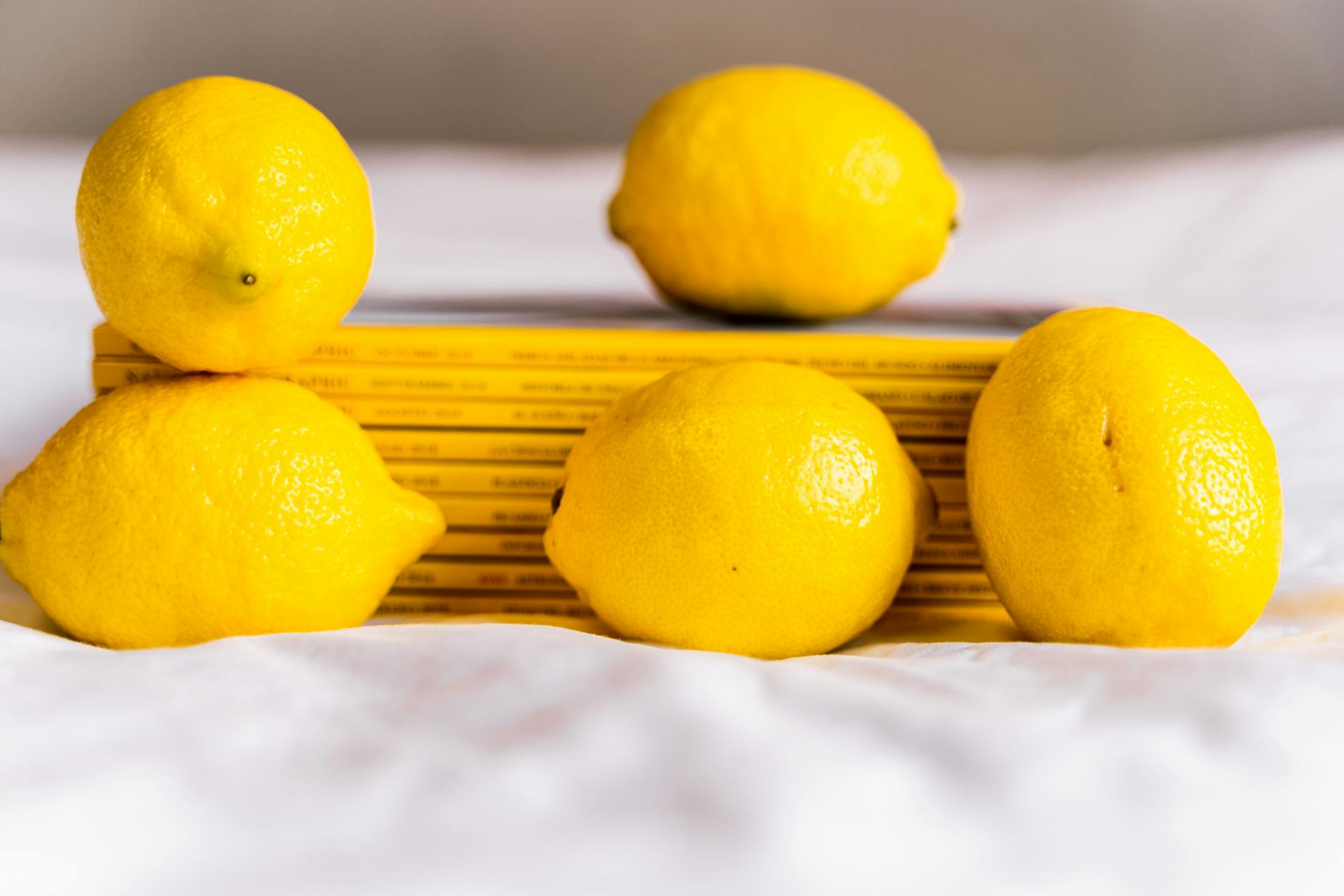 Two women smiling with lemon slices, expressing joy and confidence in their bodies
